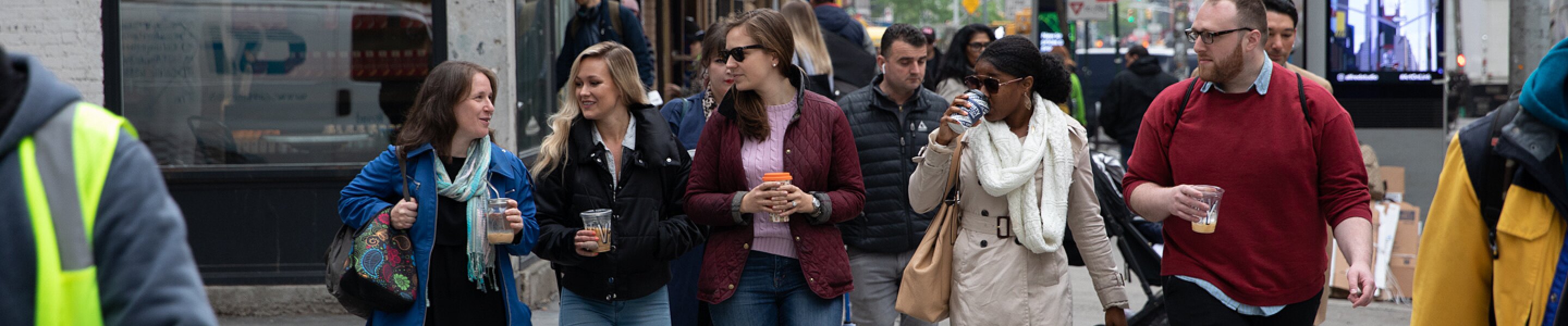 The On-Ramps team walks down a busy NYC street after a coffee break
