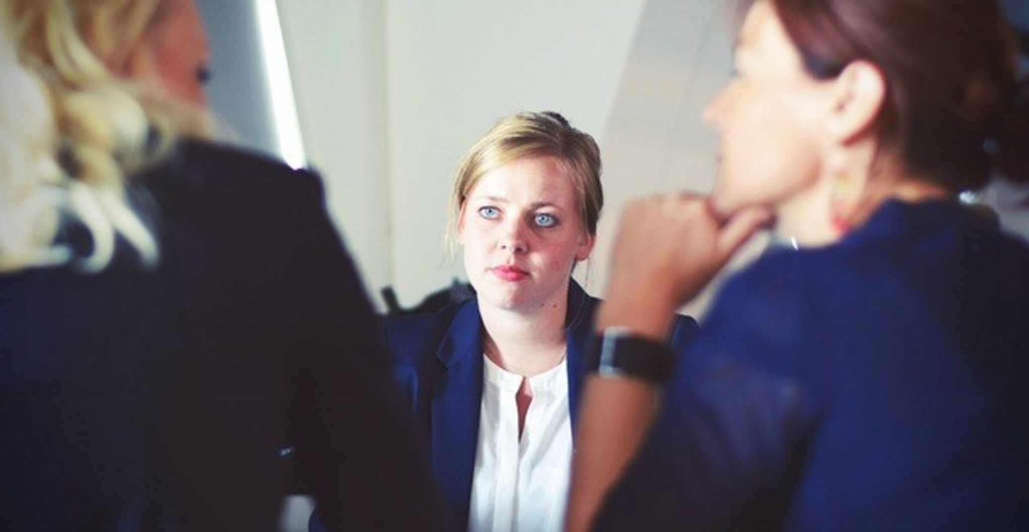 Company executives discuss an employee’s progress during her annual review