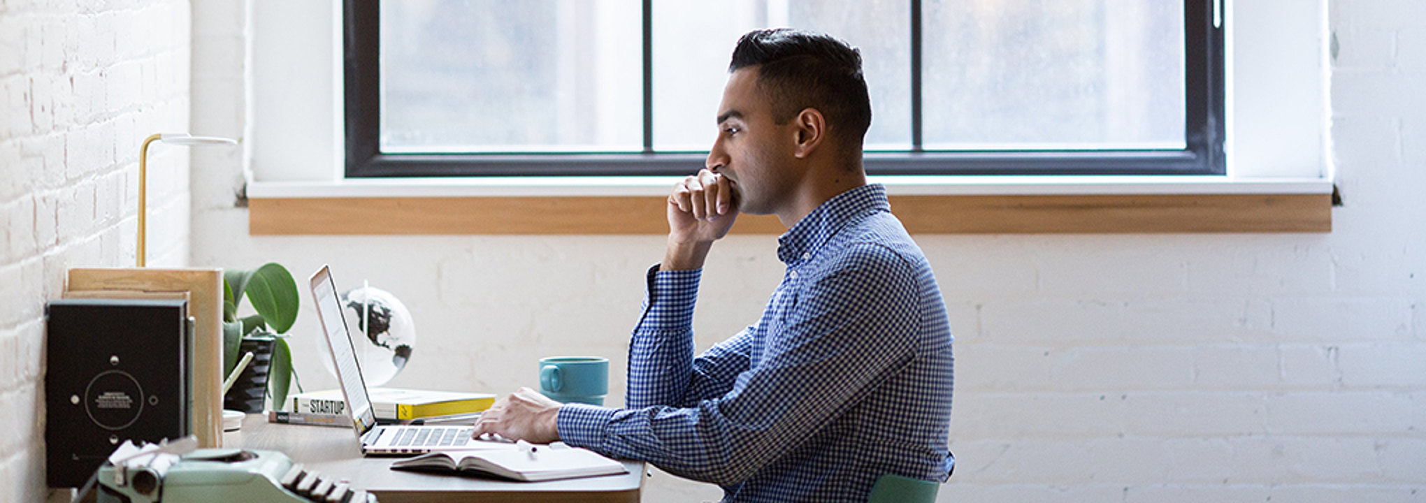 Man with computer conducting virtual interview